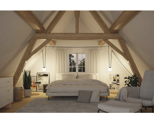 Schlafzimmer im Dachgeschoss mit Holzbalken und minimalistischem Design.