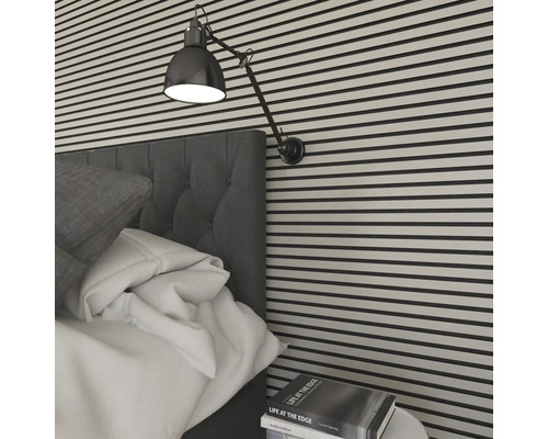 Nahaufnahme eines Schlafzimmers mit Wandpaneelen, einem Bett, einer Lampe und einem Nachttisch