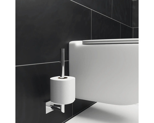 Wandhängendes WC neben einem Toilettenpapierhalter im Badezimmer.