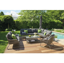 Gartenlounge-Set auf Holzterrasse mit Rasen, Bäumen und Pool im Hintergrund.