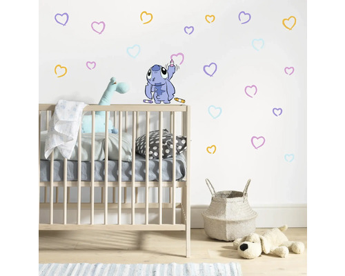 Kinderzimmer mit Kinderbett, Wäschekorb, Spielzeug und Wandtattoo mit Herzen und Stitch Motiv