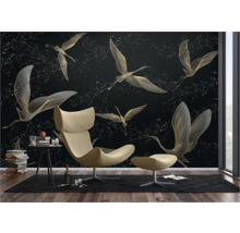 Wohnraum mit gemusterter Tapete mit Vogelmotiven, Sessel und Beistelltisch.