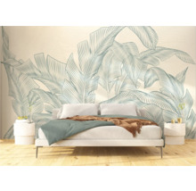 Schlafzimmer mit Bett vor einer Tapete mit botanischem Blätterdesign