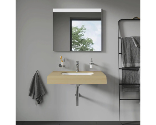 Badezimmer mit Waschtisch, Spiegel und Handtuchhalter für eine organisierte und helle Atmosphäre.