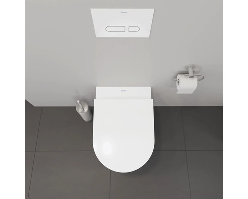 Draufsicht auf eine Toilette mit Spülkasten, Toilettenbürste und Toilettenpapierhalter.