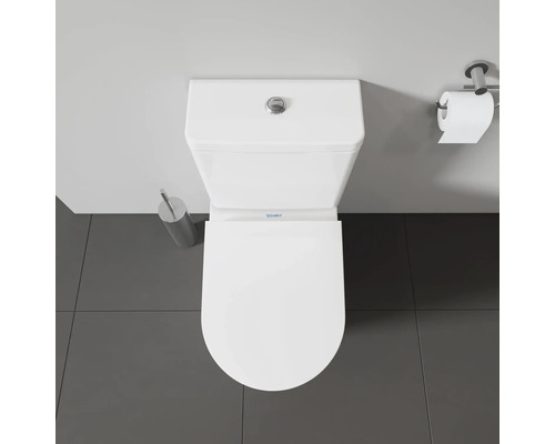Aufnahme von oben einer weißen Duravit Toilette mit Toilettenbürste und Toilettenpapierhalter