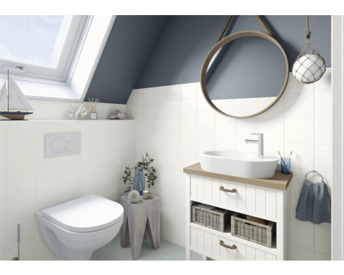 Helles Badezimmer mit Toilette, Waschbecken, Spiegel und Dachfenster