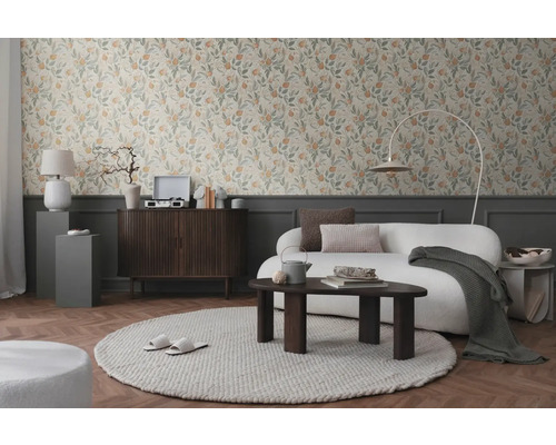 Wohnzimmer mit floraler Tapete, Sofa, Teppich und Holzmöbeln für ein gemütliches Ambiente.