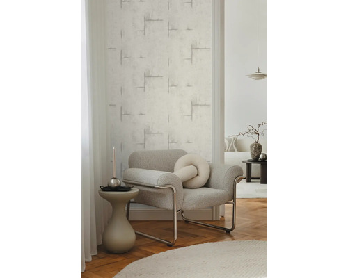 Wohnzimmer mit strukturierten Tapeten und grauem Sessel