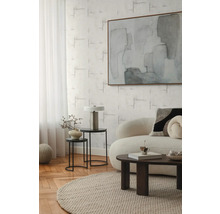 Wohnzimmer mit Sofa, Couchtisch, Beistelltischen, Lampe und abstraktem Gemälde