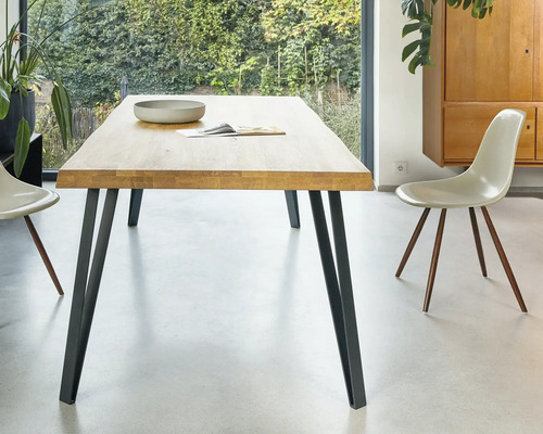 Esstisch aus Holz mit Metallbeinen und Stühlen in einem hellen Raum
