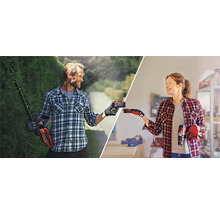 Ein Mann mit Heckenschere und eine Frau mit Bohrmaschine tauschen einen Akku aus.