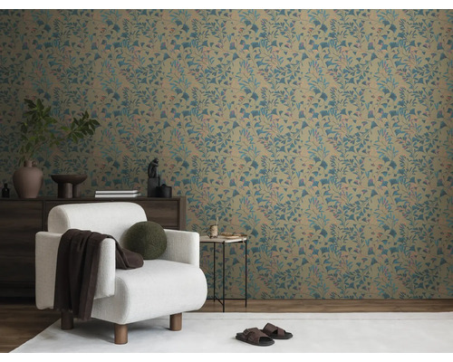 Wohnzimmer mit gemusterter Tapete, Sessel und Kommode.