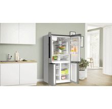 Geöffneter Kühlschrank in einer hellen Küche mit Lebensmitteln