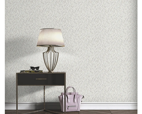 Wohnraumszene mit einer Wandtapete mit Blattmuster, einem Nachttisch, einer Lampe und einer Handtasche.