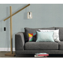 Wohnzimmer mit grauer Couch, Kissen und Stehlampe