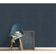 Szene mit dunkelblauer Vliestapete, Stuhl, Geschirr, Serviette und gerahmtem Bild