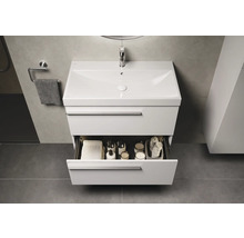 Waschtisch mit offenem Schubfach, Handtuch und Badutensilien im Badezimmer