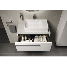 Badezimmer mit Waschbecken, offenem Unterschrank mit Handtüchern und Pflegeprodukten