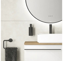 Badezimmer mit rundem Spiegel, Waschbecken, Armatur, Seifenspender und Handtuchhalter