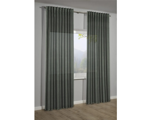 Zwei Vorhänge vor einem Fenster mit Blick in die Natur.