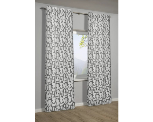 Dekorative Gardinen mit grafischem Muster vor einem Fenster.