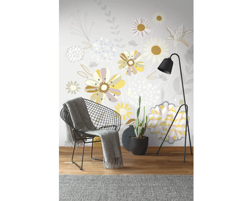 Dekorative Wandgestaltung mit Blumenmuster, Sessel, Stehlampe und Kaktus im Topf.