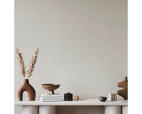 Dekorative Anordnung mit Vasen, Schalen und Büchern auf einem Regal.