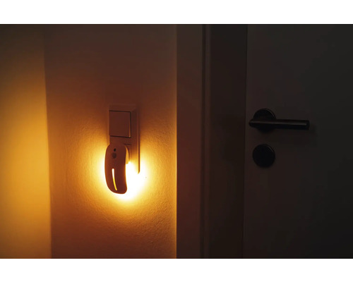 Nachtlicht mit Bewegungssensor in Steckdose neben Tür