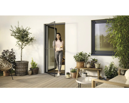 Terrasse mit Pflanzen, Gartenmöbeln, Insektenschutztür und Fenster für ein gemütliches Ambiente.