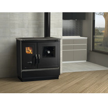 Schwarzer Küchenherd mit Sichtfenster und Feuer im Brennraum in Küchenumgebung.