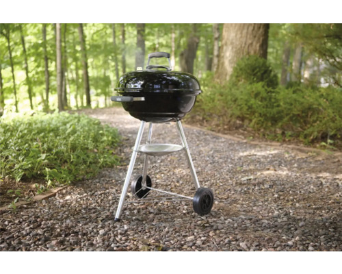 Kugelgrill mit Rollen auf Kiesweg im Garten