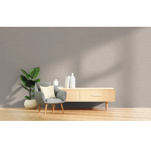 Wohnzimmer mit Sessel, Zimmerpflanze und Sideboard