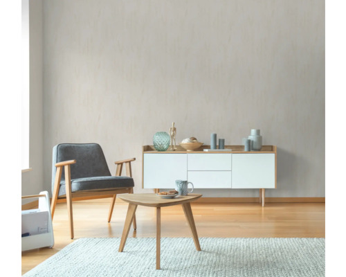 Wohnzimmer mit Sessel, Sideboard und Couchtisch auf einem Teppich