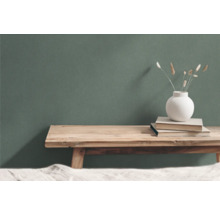 Dekorative Szene mit Holzhocker, Buchstapel und Vase mit Trockenblumen