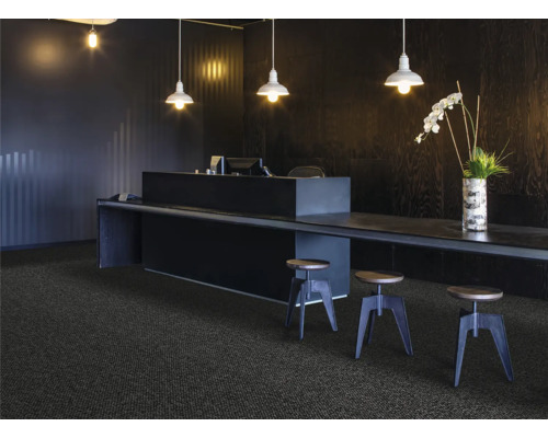 Empfangsbereich mit Teppichboden, Schreibtisch und Barhockern unter Hängelampen