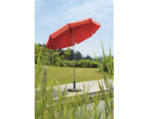 Roter Sonnenschirm im Gartenbereich auf Holzterrasse