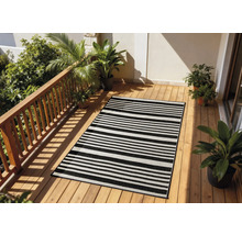 Terrasse mit einem gestreiften Teppich, Holzfußboden und Pflanzen