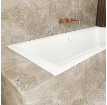 Eingebaute Badewanne mit Armatur an Marmorwand