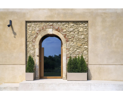 Fassade mit Steintürbogen und bepflanzten Pflanzkästen