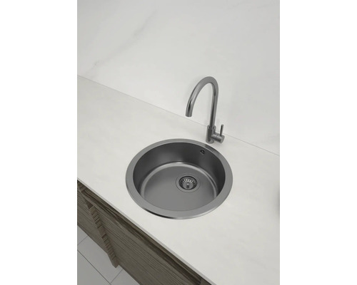 Runde Edelstahlspüle mit Wasserhahn auf einer Arbeitsplatte