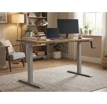 Höhenverstellbarer Schreibtisch mit Handkurbel, Laptop und Monitor in einem hellen Raum.