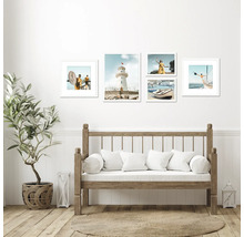 Wohnraum mit Holzbank, Zimmerpflanze und Wandbildern mit maritimen Motiven.