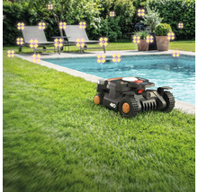 Szene mit einem Rasenmähroboter neben einem Pool, umgeben von Gartenmöbeln und Pflanzen.