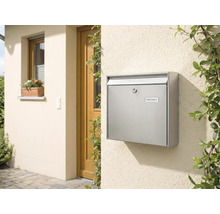 Briefkasten aus Edelstahl an einer Hauswand neben einer Tür