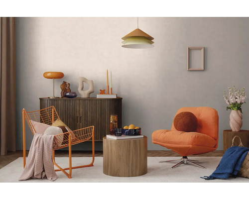 Modernes Wohnzimmer mit orangem Polstersessel, orangem Drahtstuhl, Sideboard aus dunklem Holz, runden Holztischen und einer Pendelleuchte.