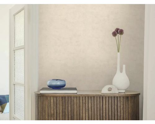 Strukturierte beige Tapete an einer Wand hinter einem hölzernen Sideboard mit Dekoration. Helle, aufgeräumte Raumatmosphäre.