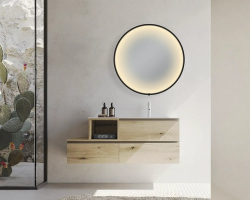 Modernes Badezimmer mit Waschtisch, rundem Spiegel mit Hintergrundbeleuchtung und Glasduschwand.