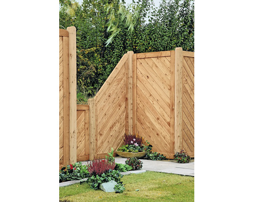 Holzzaun mit diagonalen Brettern und bepflanzten Blumenkästen im Garten