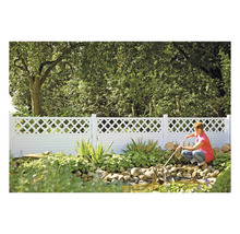 Gartenszene mit einem weißen Zaun und einer Person, die einen Teich reinigt